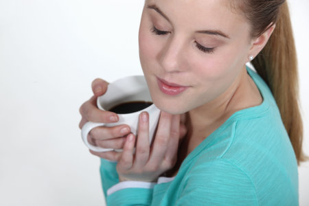 Woman warming herself with mug of coffee