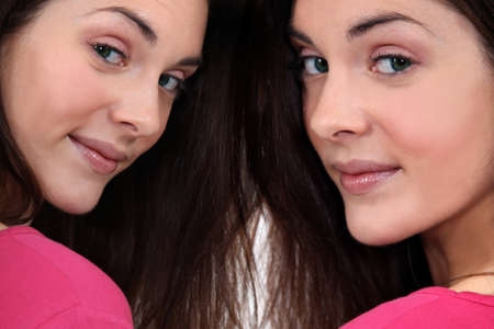 Twins with thick, brown hairの写真素材