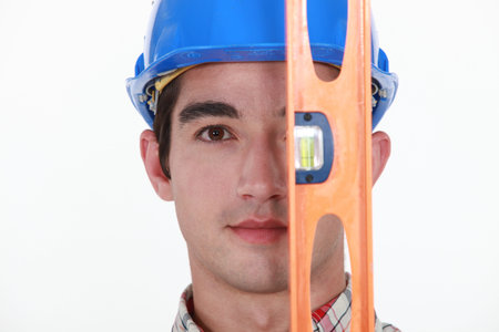 Man holding spirit-level over face