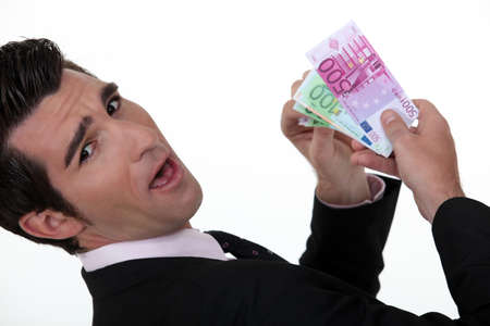 Happy businessman holding banknotesの写真素材