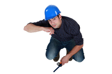 Crouching man with hammer