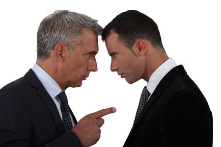 Younger and older businessmen head to headの写真素材