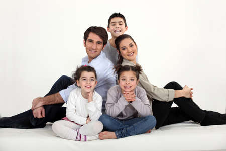 Young family all sat on the floorの写真素材