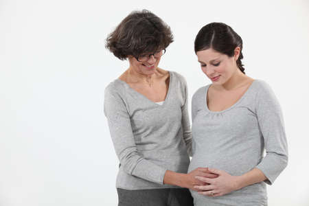 Pregnant woman with her motherの写真素材