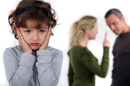 Little girl upset by parents arguingの写真素材