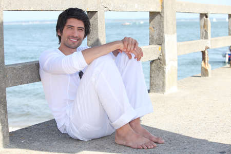 Man relaxing by the seaの写真素材