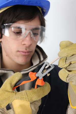 craftsman cutting a cableの写真素材