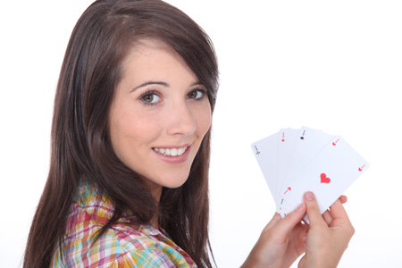 Young brunette with poker cards