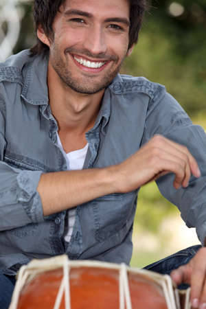 Bongo player sat in parkの写真素材