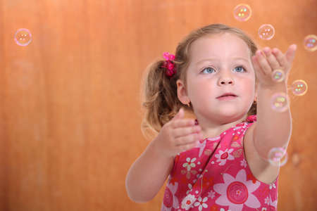 portrait of a little girl with bubblesの写真素材