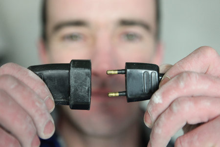 Man holding an electrical cable