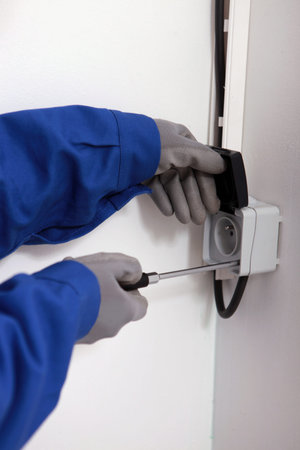 Worker fixing a plug