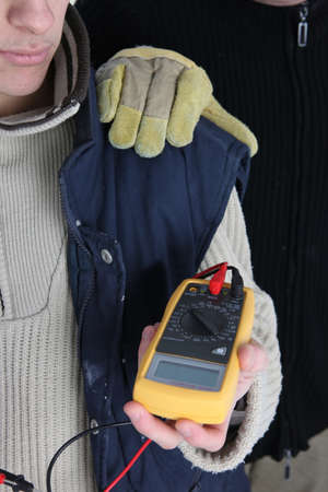 Electrician with an ampmeterの写真素材