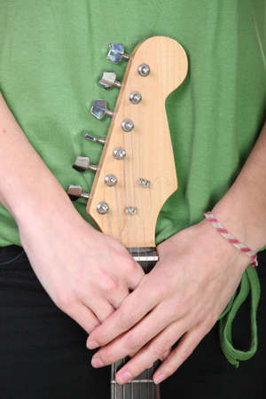 Young woman holding guitarの写真素材