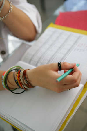 Teenager writing in her work bookの写真素材