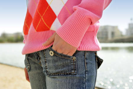 Woman with her hand in her jean pocketの写真素材