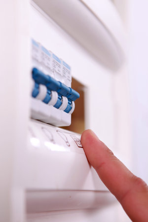 close-up of an electricity meter and a finger
