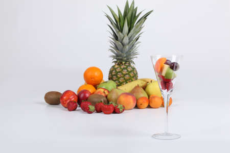 Variety of fresh fruit and a glassの写真素材