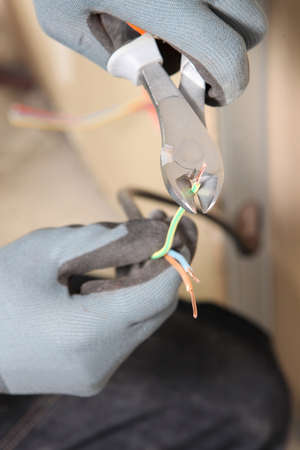 Electrician using electricial wire clippersの写真素材
