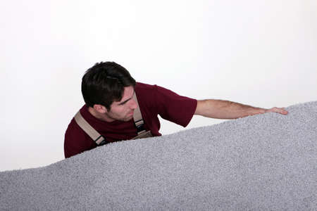 Man laying carpetの写真素材