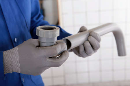 A plumber attaching two components togetherの写真素材