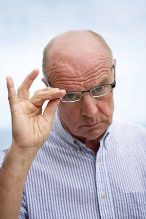 Bald man wearing glasses outdoorsの写真素材