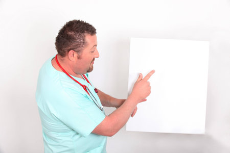 Doctor pointing to a blank signの写真素材