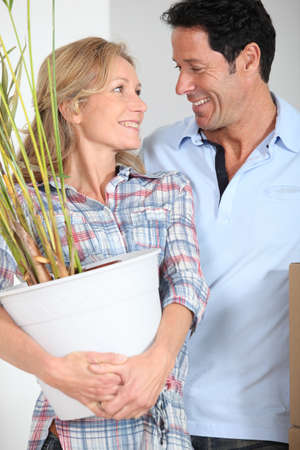 Couple smiling with plantの写真素材