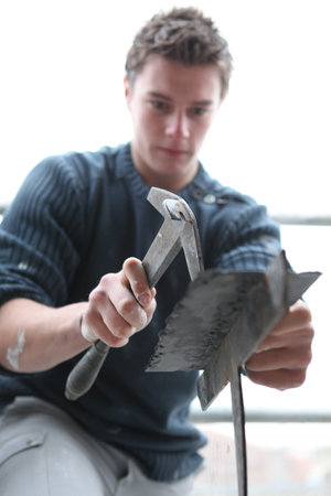 Man using a specialist roofing hammer