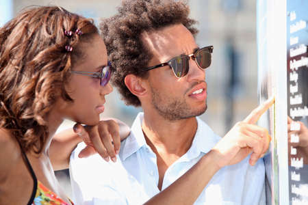 Couple looking at signの写真素材