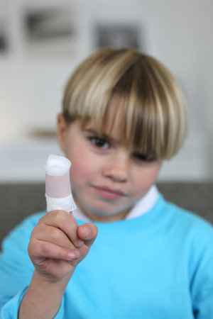 Little boy with bandage on finger