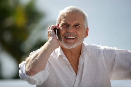 Happy older man with a cellphone