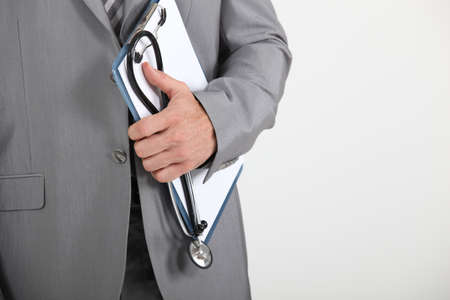 Man holding clipboard and stethoscopeの写真素材