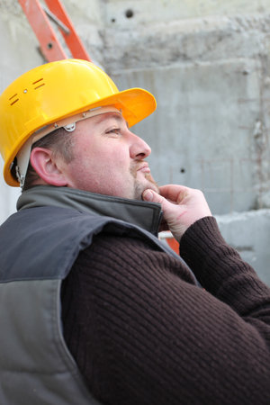 Worker stroking his chin