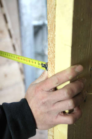 Man measuring woodの写真素材