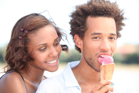 Couple with ice cream walkingの写真素材