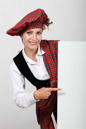Scottish woman pointing at white boardの写真素材