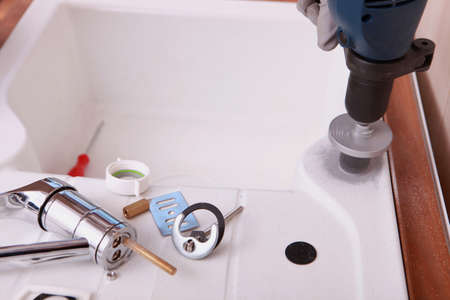 a sink and plumbing pieces and toolsの写真素材