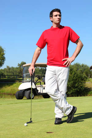 Golfer Standing next to the holeの写真素材