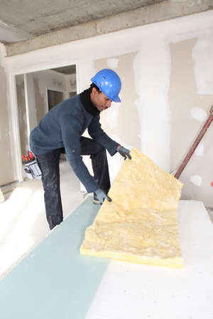 Construction worker with wall insulationの写真素材