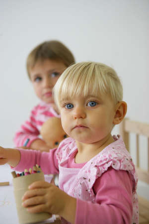 Toddlers with crayonsの写真素材