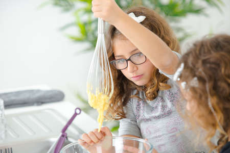 Two sisters bakingの写真素材
