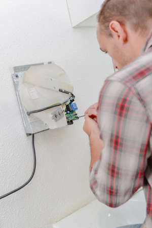 Finally fixing the hand dryerの写真素材