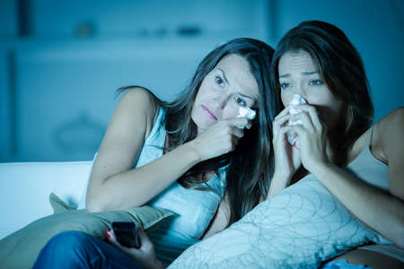 Woman crying whilst watching a movieの写真素材
