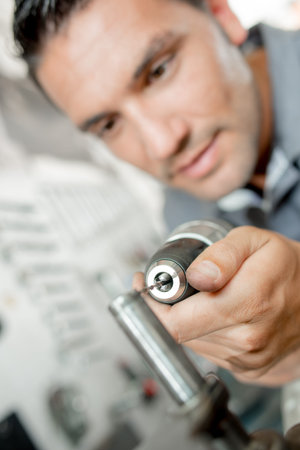 Mechanic using a power drill