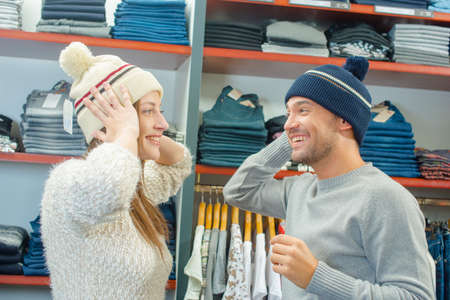 Playful Couple trying on hatsの写真素材