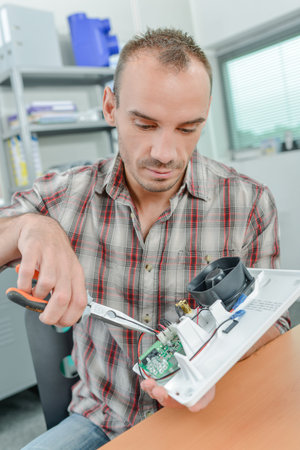 Man repairing cooling fan