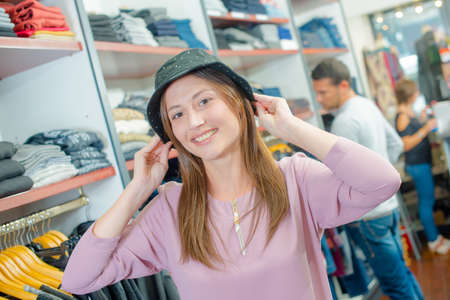 Lady trying on hatの写真素材