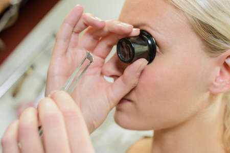 Looking through magnifying eye glassの写真素材