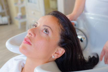Hairdresser washing a woman's hair